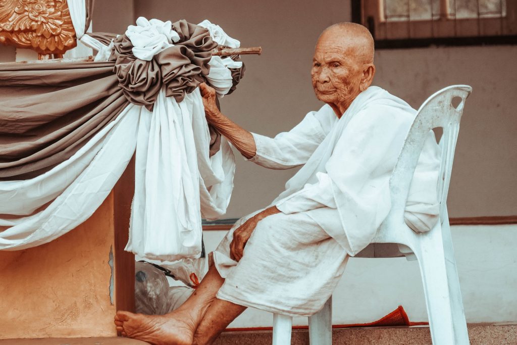 Ein alter Mann sitzt auf dem Stuhl